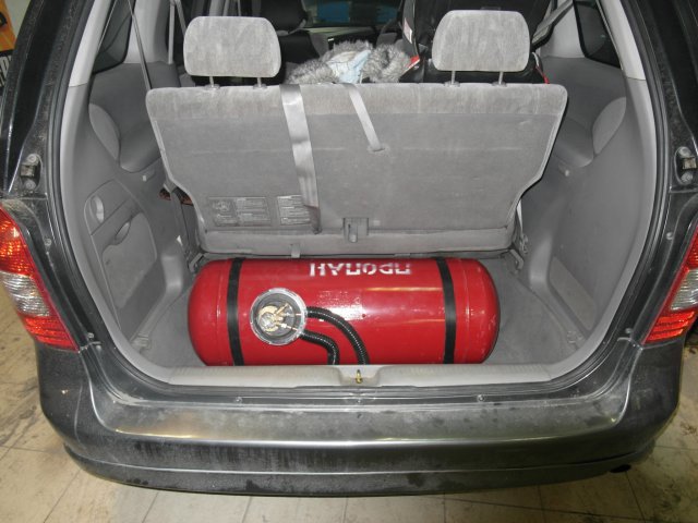 Цилиндрический газовый баллон объемом 90 л установлен в нишу багажника Mazda MPV
