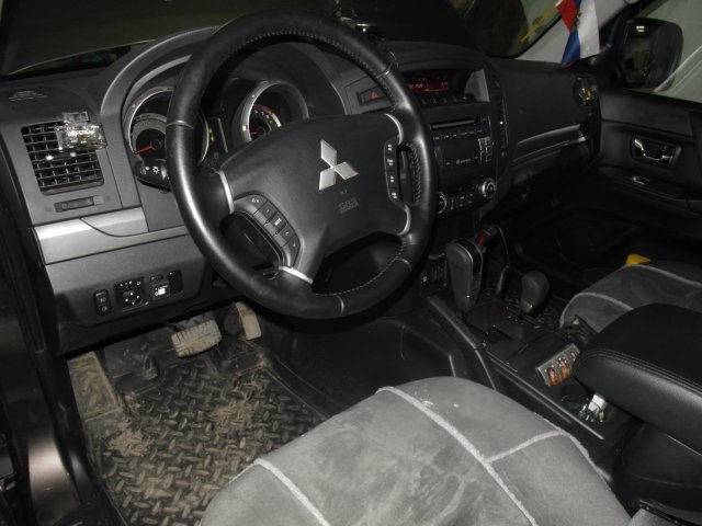 Кнопка переключения режимов работы размещена в стандартную заглушку слева от руля Mitsubishi Pajero 4, V6 3.0L